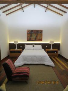 une chambre avec un grand lit blanc et un canapé dans l'établissement Pousada Casa das Fontes, à Tiradentes 83 autres photos