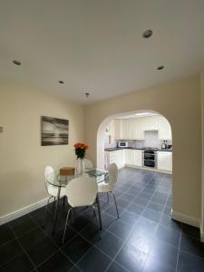 a kitchen and dining room with a table and chairs at Isle of Anglesey Spacious Home in Llanfairpwllgwyngyll