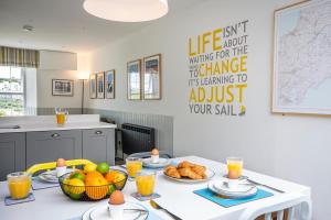 a kitchen with a table with food on it at Seafarers, Mevagissey - Coastguard Cottage overlooking harbour in Mevagissey