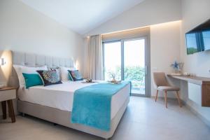 a bedroom with a bed and a large window at Grande Mandi & Jani Villa in Laganas