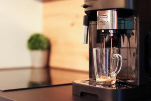a coffee maker sitting on a counter with a cup at 'NAP' apartment in Osijek
