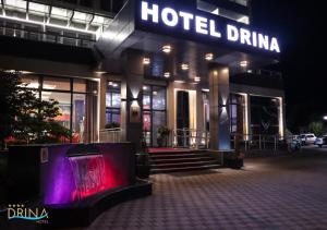 a hotel entrance with a hotel clinic at night at Drina Hotel in Bijeljina