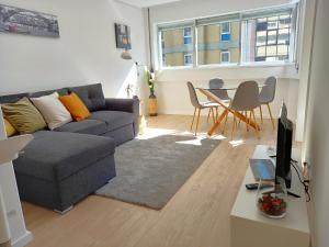 ein Wohnzimmer mit einem Sofa und einem Tisch in der Unterkunft OportoView Prestige Apartment in Porto