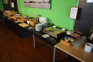 a buffet line with food on a table at Hotel am Bahnhof in Waren