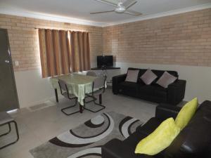 a living room with a couch and a table at Sunrise Units in Hervey Bay