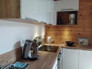 a kitchen with a counter with a coffee maker on it at Le Carré de Bois in Briançon