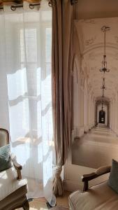 a room with a large window and a long corridor at La Martinoise Patio in Saint-Martin-de-Ré