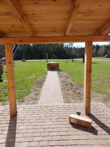 a wooden pavilion with a bench in a park at Oaza spokoju in Ramsówko +2 photos