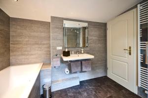 a bathroom with a sink and a mirror at Hotel Belvedere in Warnemünde