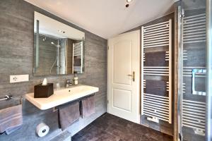 a bathroom with a sink and a mirror at Hotel Belvedere in Warnemünde