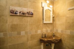 a bathroom with a sink and a mirror at Casa el Mar apartamento El Faro in Güimar +12 photos
