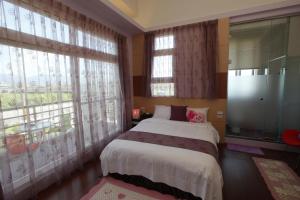 Postel nebo postele na pokoji v ubytování Jing Xiang Hua Nong B&B
