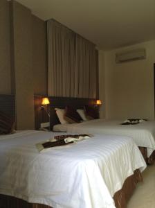 Katil atau katil-katil dalam bilik di K Garden Hotel (BS)