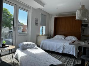 Кровать или кровати в номере Texelheerlijk 18