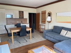 a living room with a couch and a table at Landhaus Lassnig in Moosburg