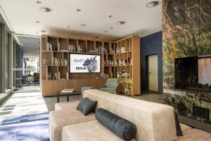 a living room with a couch and a fireplace at June Six Hotel Berlin City West in Berlin