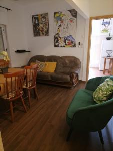 ein Wohnzimmer mit einem Sofa und einem Tisch in der Unterkunft Casa das 4 estações in Castelo Branco