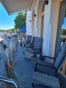 a row of chairs sitting on the side of a building at Hotel Belvedere in Warnemünde
