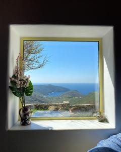 a window with a view of the ocean at Livas Residence in Megálon Khoríon