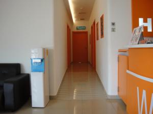 a hallway in a hospital with a red door at 1 Hotel Kuchai Lama in Kuala Lumpur