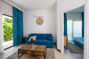 a living room with a blue couch and a table at Bitez Garden Life in Bitez