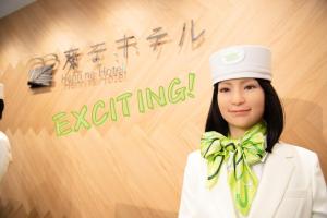a woman wearing a white hat and a green bow tie at Henn na Hotel Tokyo Akasaka in Tokyo