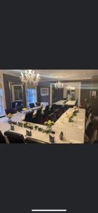 a large conference room with tables and chairs and chandeliers at Y Castell in Caernarfon