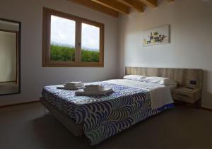 En eller flere senge i et værelse på B&B Il Vigneto