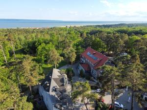 an aerial view of a house with trees and the water at "Apollo" - domek, apartamenty i pokoje z klimatyzacją in Krynica Morska