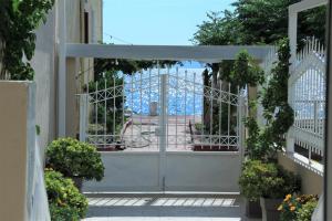 an open gate with a view of the ocean from a house at Asteri Apartments Mytikas 2-Bedroom Seaview Courtyard in Mitika