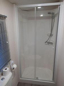 a bathroom with a shower with a glass door at Liberty-5 in Slaley