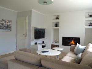 a living room with a couch and a table at Haus Muehlenblick in Borgsum