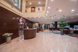 a lobby with a reception desk in a building at Lion's Garden Hotel in Budapest