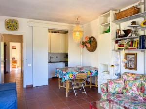 a living room with a table and a couch at Il Giardino del Volterraio in Rio nellʼElba