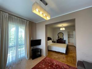 a bedroom with a bed and a large window at Villa Semashko in Bar