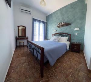 a bedroom with a bed and a mirror in it at Villa Ilios in Fira