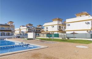 a resort with a swimming pool and some buildings at Cozy Home In Torrevieja With Wifi in Torrevieja