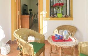 a table with two chairs and a table with cups on it at Cozy Home In Torrevieja With Wifi in Torrevieja