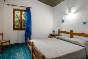 a bedroom with a bed and a window at Villa Bados 8 - Klodge in Olbia