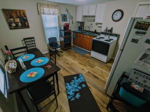 a kitchen with a table and chairs and a refrigerator at The Estate Loft in Downtown Milford in Milford