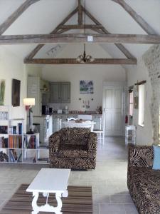 a living room with a couch and a table at Gîte de l'Octroy Poitou in Oiron