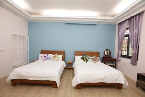 Postel nebo postele na pokoji v ubytování 小葉園民宿Little Ya B&B