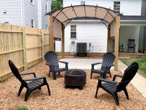 a group of chairs around a fire pit in a backyard at Newly Remodeled Stouchsburg Cottage in Myerstown