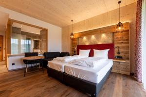 a bedroom with a large bed and a table at Landhotel Zum Goldenen Kreuz in Moosbach