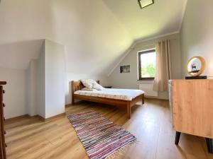 a bedroom with a bed and a window and a rug at Apartament pod lipką in Lutowiska