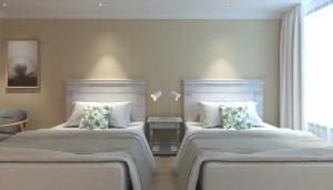 Säng eller sängar i ett rum på Gardi Hotel & Suites