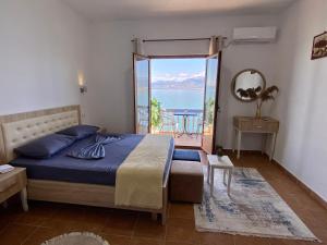 a bedroom with a bed and a view of the ocean at Bella Vista in Shkodër