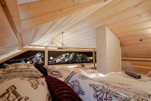 a room with a bed with pillows on it at Podhalańska Ostoja Apartament in Biały Dunajec