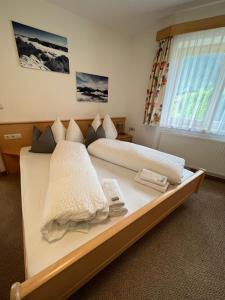 a bedroom with two beds with towels on them at Haus Abendrot in Sankt Anton am Arlberg