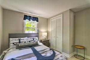 een slaapkamer met een groot bed en een raam bij Adorable West Yarmouth Home about 2 Mi to Beach! in West Yarmouth